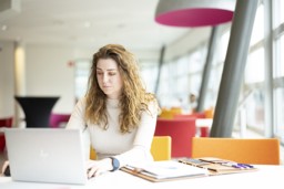 Student behind her laptop